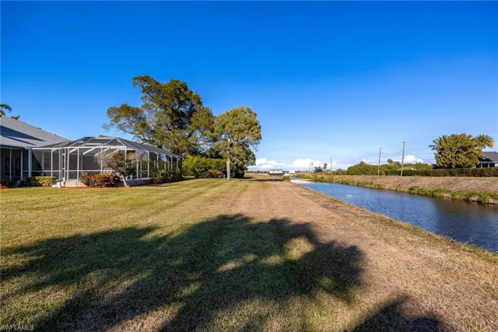 View of grassy yard, and water view