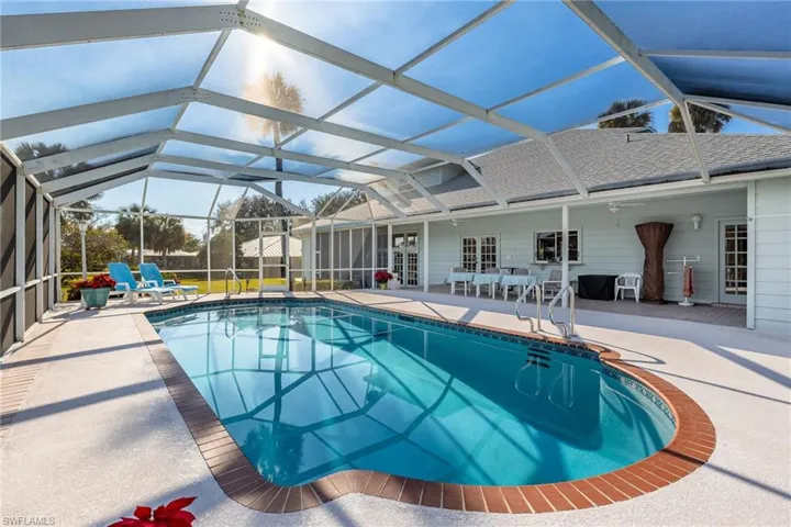 Swimming pool with screened in patio