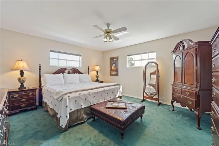Bedroom with a ceiling fan, and multiple windows