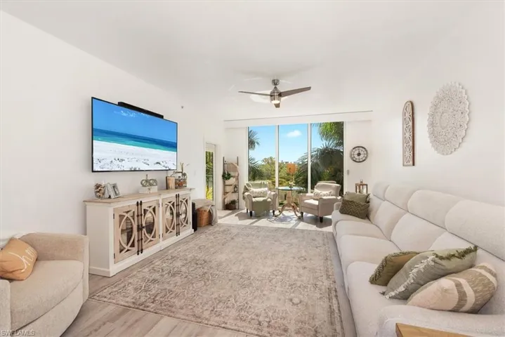 Living room featuring ceiling fan and wood finished floors