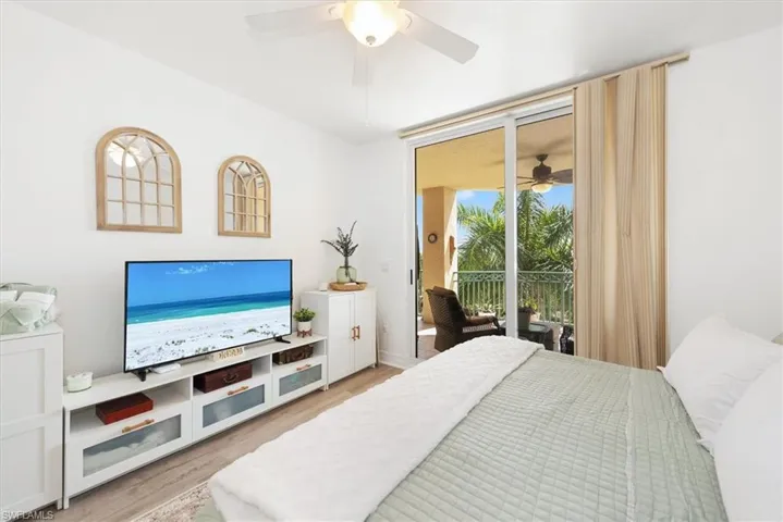 Bedroom featuring light wood-type flooring, a ceiling fan, and access to outside