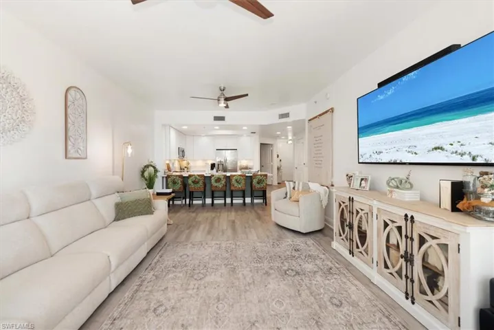 Living area featuring light wood-type flooring and ceiling fan