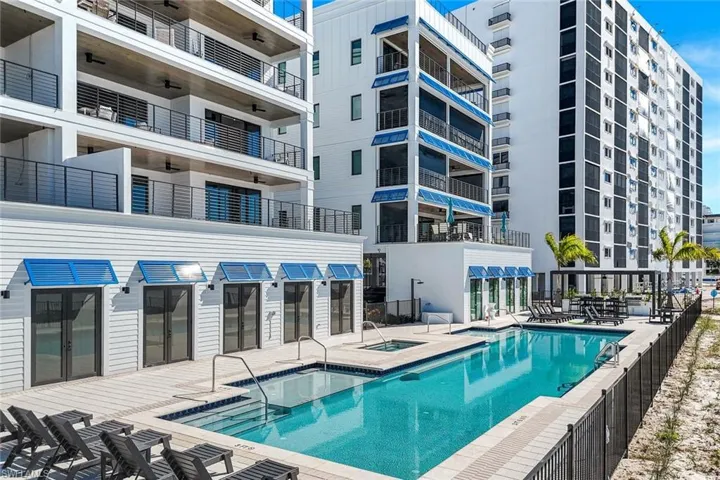 Community pool featuring a community hot tub and a patio