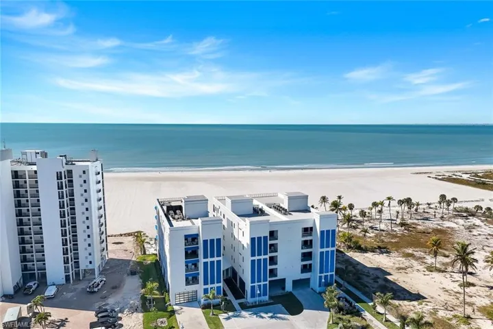 Drone / aerial view of expansive beach and apartment complex / building