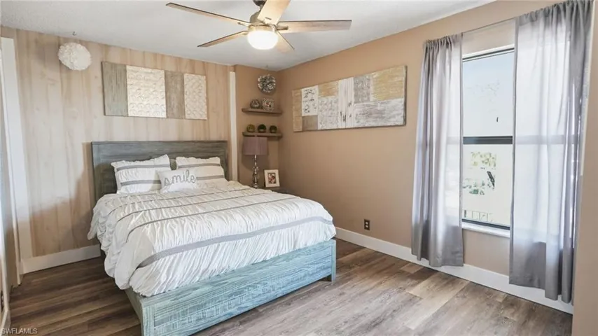 2nd Bedroom with a queen size bed, nightstand, ceiling fan, and a walk in closet.