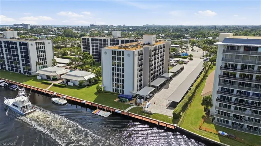 Aerial view of the buidling with the river frontage and a boat going by