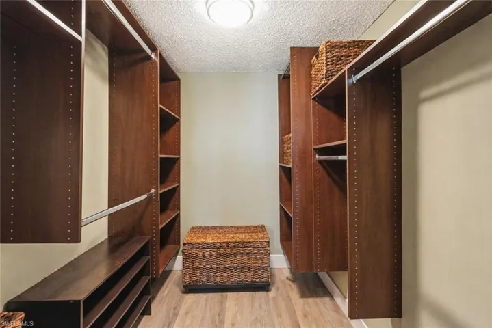 Master Closet with dark wood organization