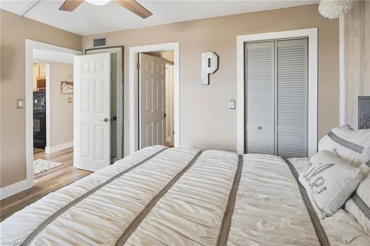 2nd Bedroom with a queen size bed, nightstand, ceiling fan, and a walk in closet.