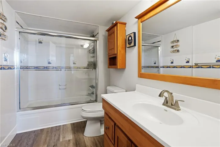 Master bathroom featuring a tub/shower combo with glass doors.