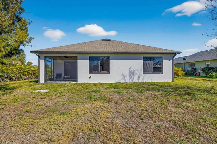 Back of property featuring ample yard space and plenty of room for a pool package.