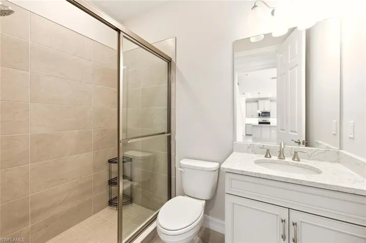 Bathroom featuring a stall shower and vanity