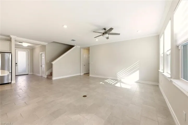 Unfurnished living room featuring ceiling fan, ornamental molding, and recessed lighting