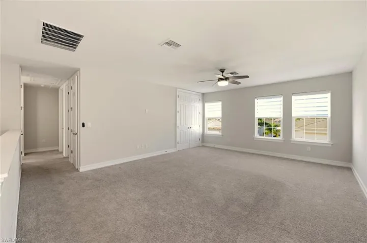 Spare room with light carpet and ceiling fan