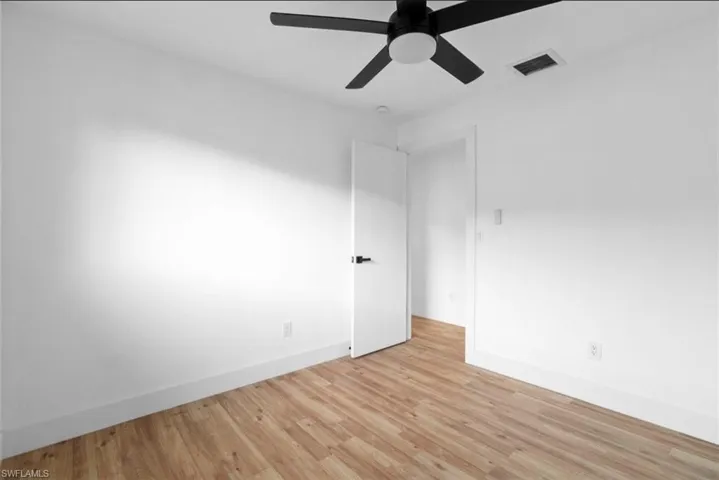 Spare room featuring light wood-style floors and ceiling fan