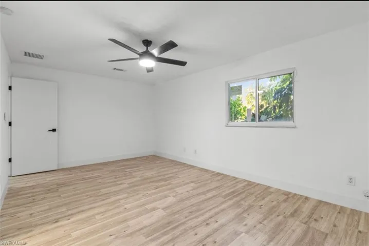 Unfurnished room with light wood-style floors and a ceiling fan