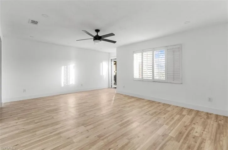 Spare room with light wood-style floors and a ceiling fan