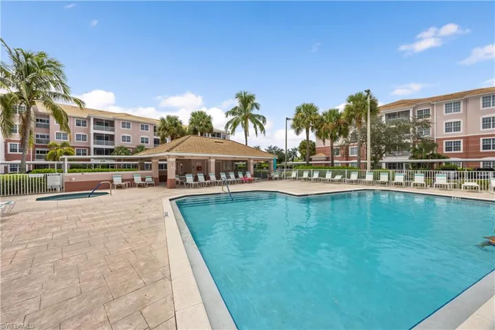 Community pool featuring a patio, a gazebo, and fence