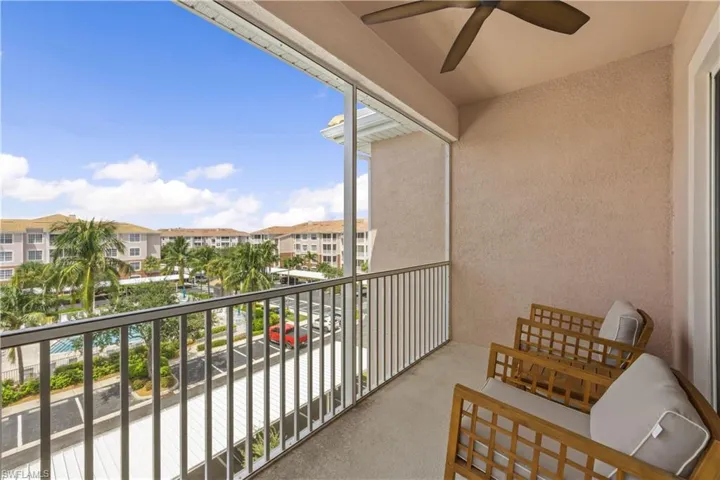 Balcony with a residential view and a ceiling fan