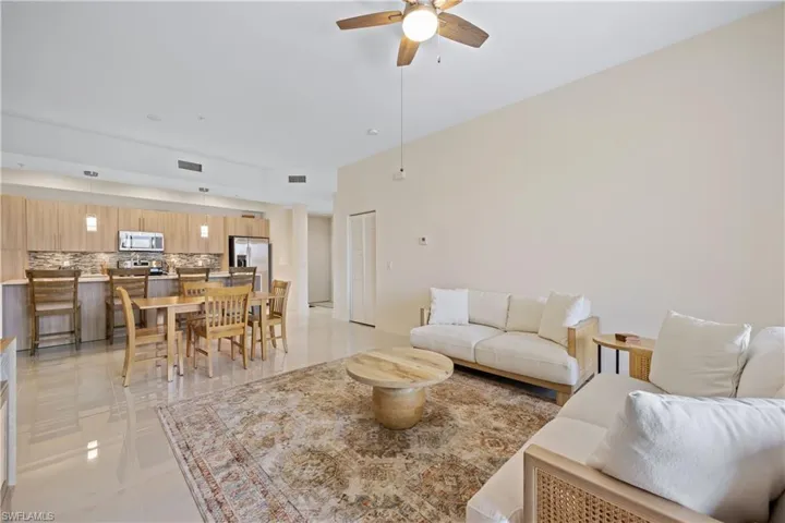 Living area featuring visible vents and a ceiling fan