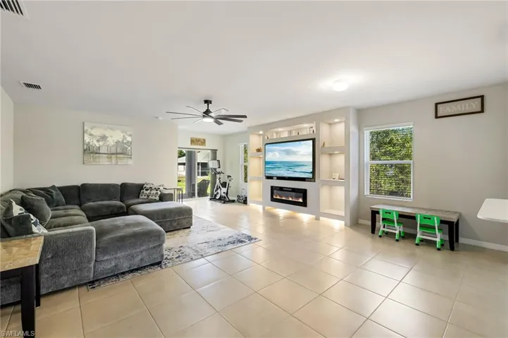 Tiled living room featuring ceiling fan