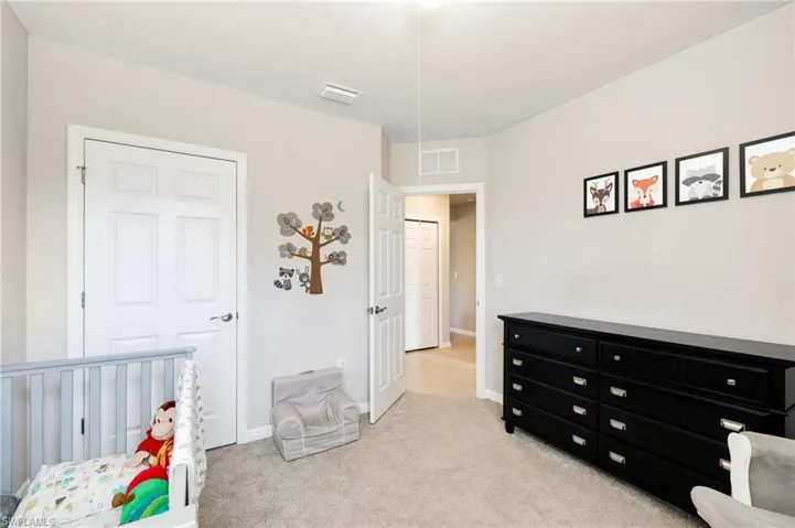Carpeted bedroom with a crib