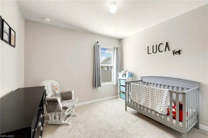Carpeted bedroom with a nursery area