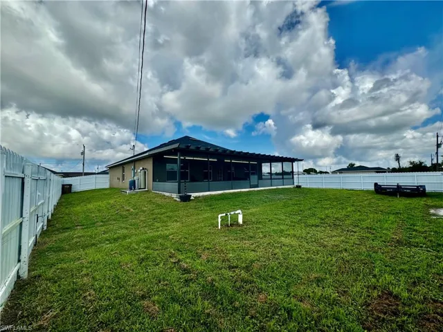 View of yard featuring a sunroom