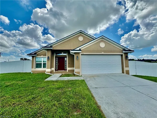 Ranch-style house with a front lawn and a garage