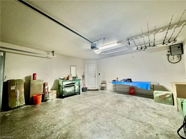 Garage featuring a garage door opener