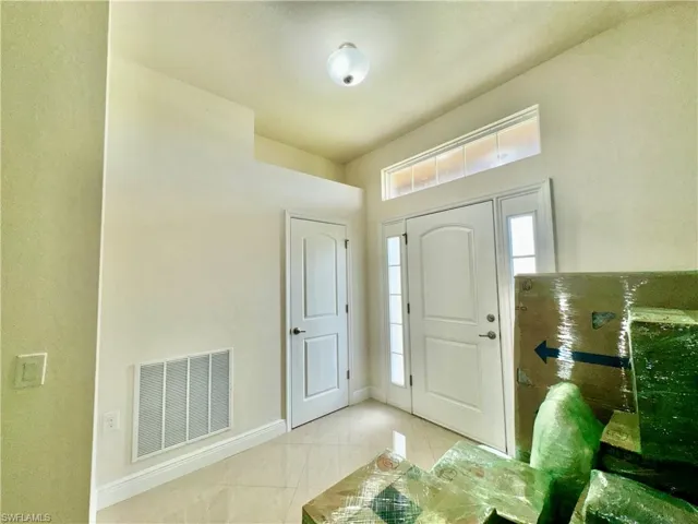 Foyer featuring light tile patterned floors