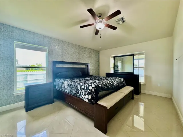 Tiled bedroom with ceiling fan