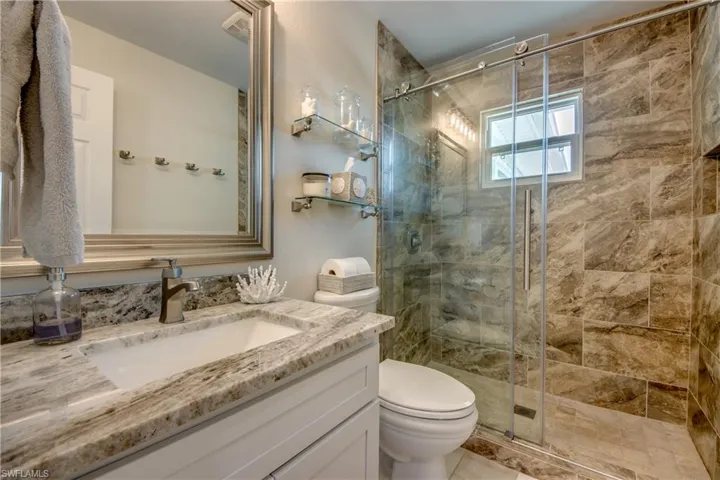Bathroom featuring vanity and a stall shower