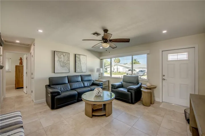 Living room with recessed lighting, ceiling fan, and light tile patterned floors