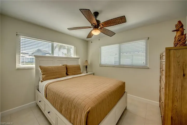 Bedroom featuring light tile patterned floors and a ceiling fan