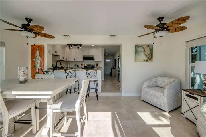 Dining space featuring a ceiling fan and light tile patterned floors