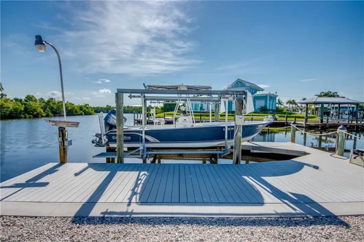 Dock area featuring boat lift and a water view