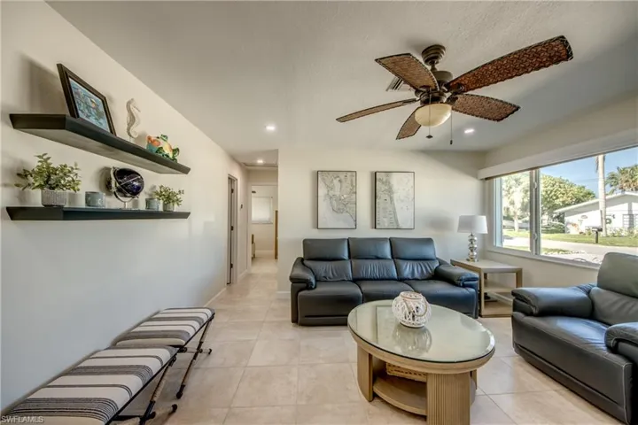 Living room with recessed lighting, a ceiling fan, and light tile patterned floors
