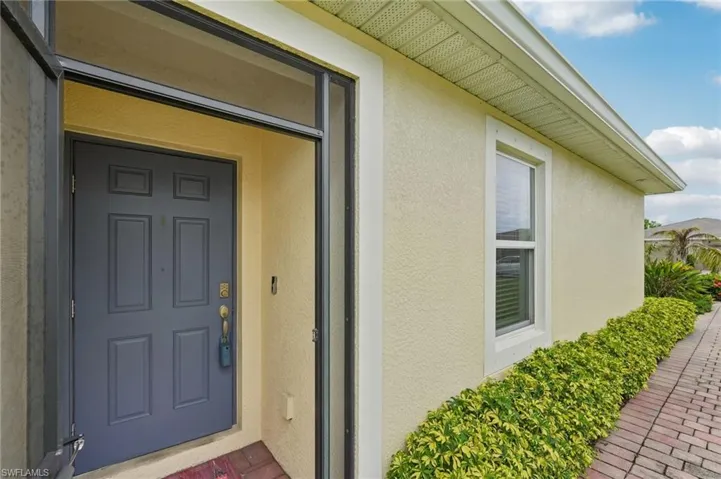 View of exterior entry with stucco siding