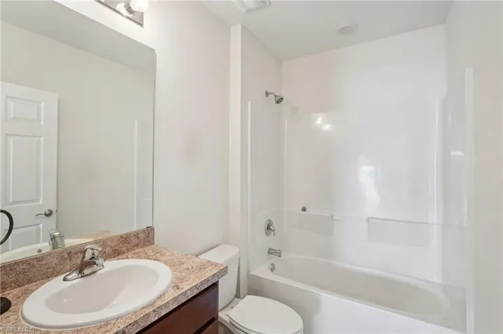 Bathroom featuring bathing tub / shower combination and vanity