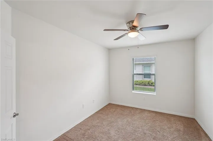 Unfurnished room with light carpet and ceiling fan