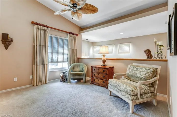 Living area featuring plenty of natural light, carpet flooring, lofted ceiling, recessed lighting, and a ceiling fan