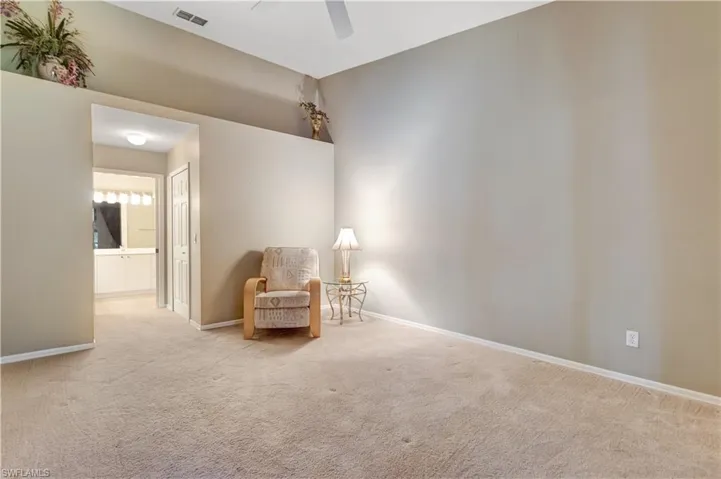 Sitting room featuring carpet floors and a ceiling fan