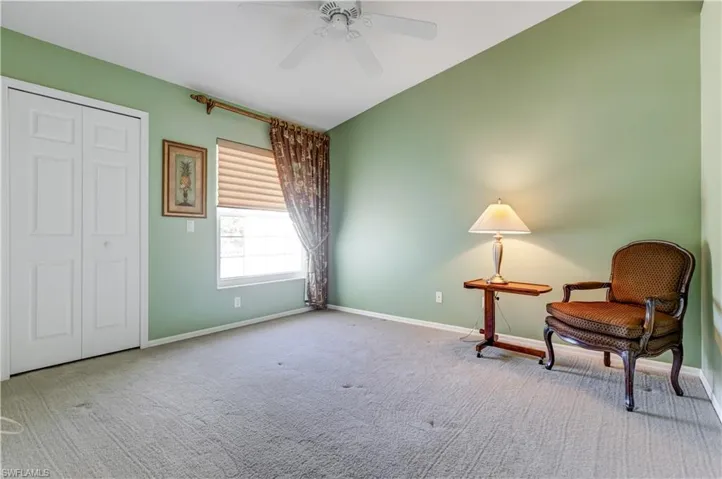 Living area featuring carpet floors and ceiling fan