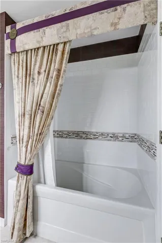 Full bath featuring shower / bath combo with shower curtain