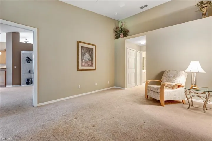 Living area featuring carpet flooring and ceiling fan