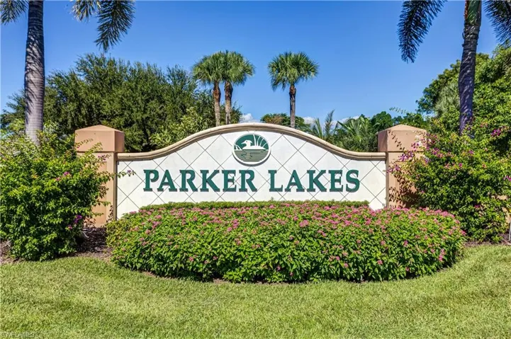 Community / neighborhood sign featuring a yard