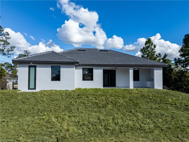 Rear view of property featuring a yard