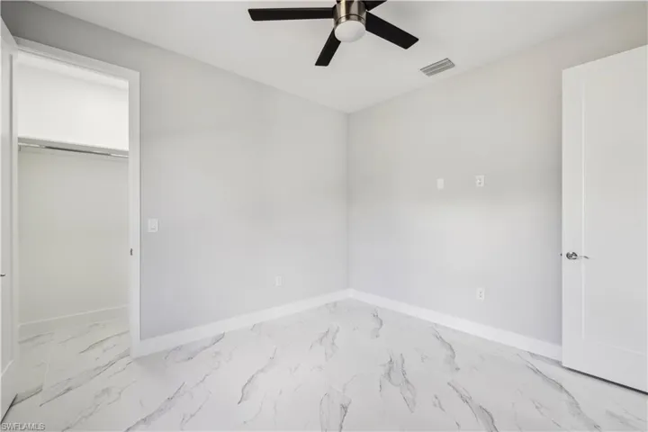 Unfurnished bedroom with a closet and ceiling fan