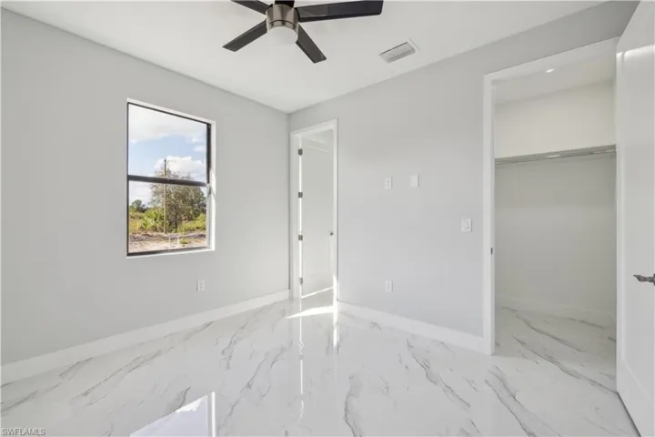 Bedroom featuring ceiling fan and a closet