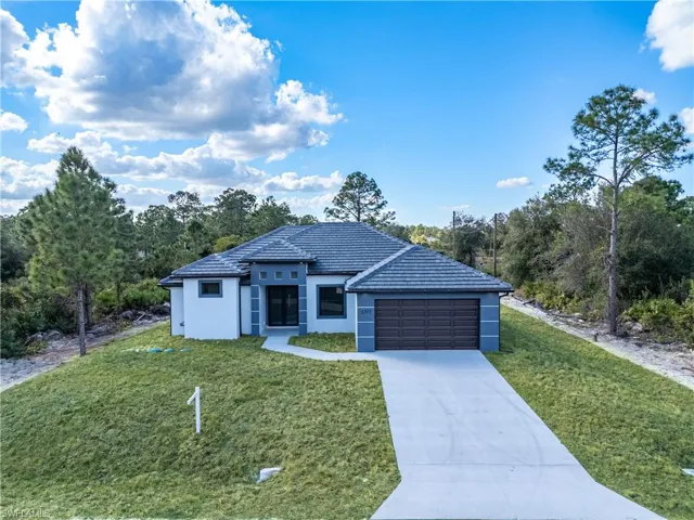 Ranch-style house with a garage and a front yard